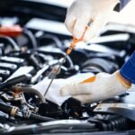 Mechanic working on car engine repairs