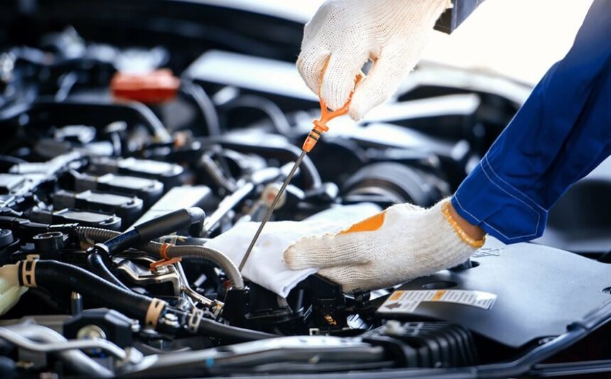 Mechanic working on car engine repairs